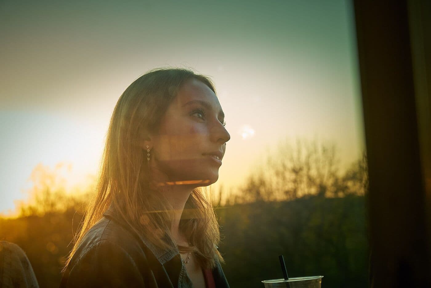 Woman in profile against the sunset, still from a production for an energy client